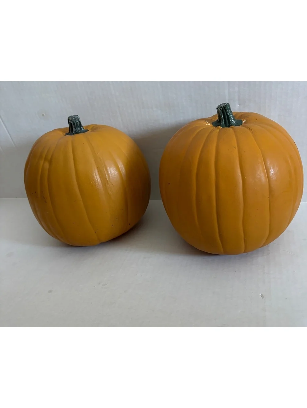 2 fake pumpkins